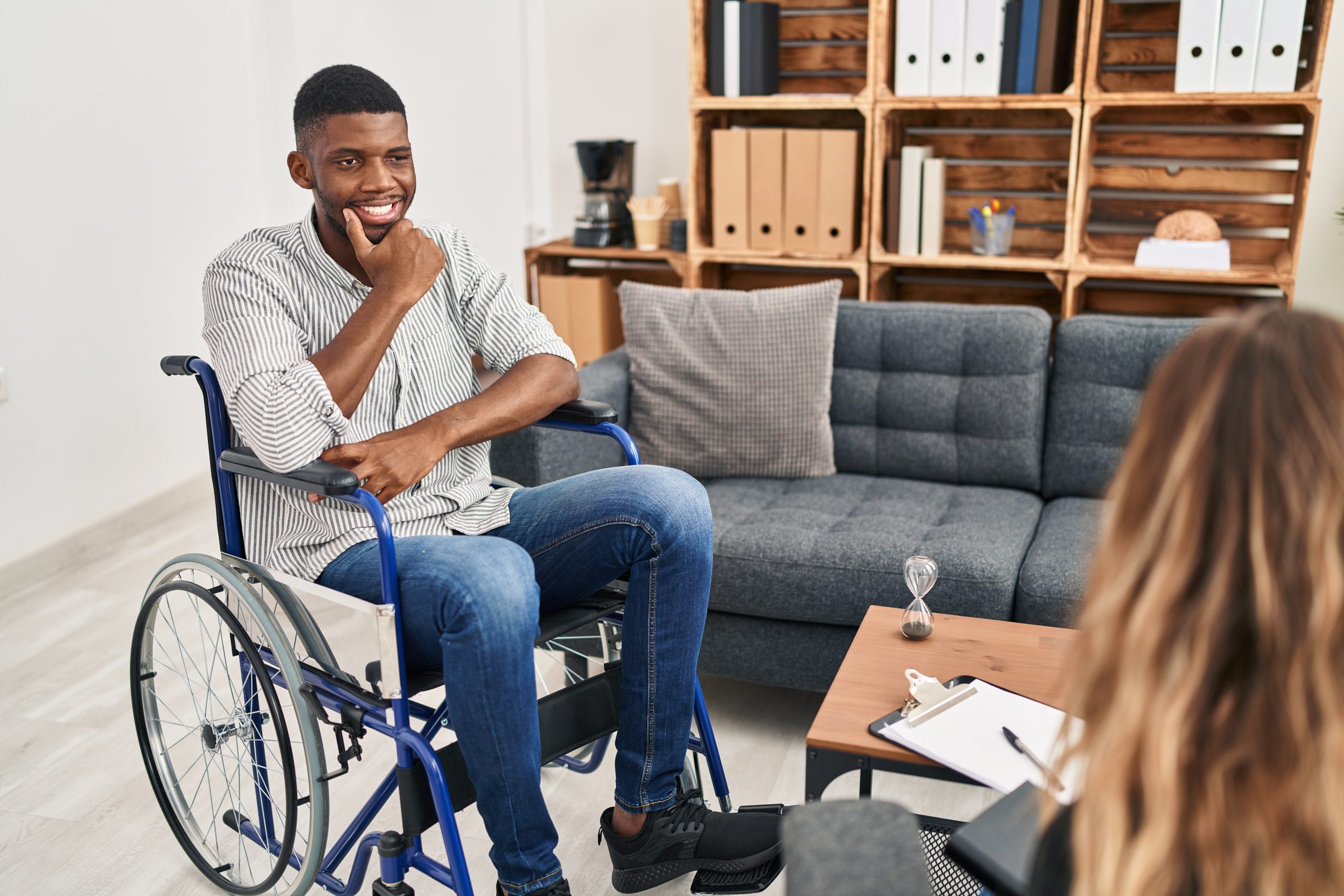 Man in wheelchair talking to mental health therapist